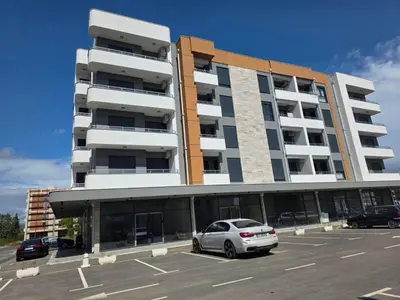 a car parked in a parking lot in front of a building at S&M Stan in Ulcinj