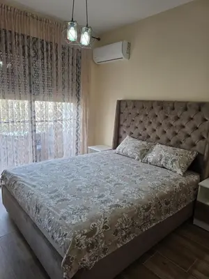 a bedroom with a large bed with a large window at S&M Stan in Ulcinj