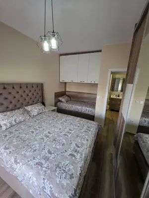 a bedroom with a large bed in a room at S&M Stan in Ulcinj