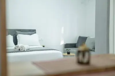 a bedroom with a white bed with towels on it at NOVA Apartments in Ulcinj