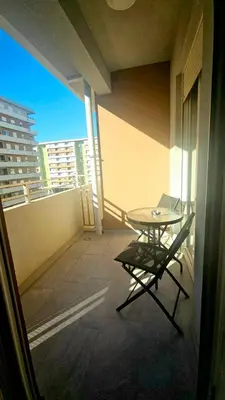 a balcony with a table and a chair on a building at CL Home Lux in Podgorica