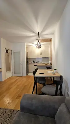 a living room with a table and a couch at CL Home Lux in Podgorica