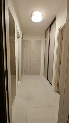an empty hallway with a door and a tile floor at CL Home Lux in Podgorica