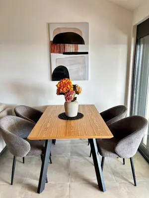 a dining room table with a vase of flowers on it at Apartment Sunset - Private Pool & Sea View in Bar