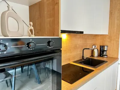 a kitchen with a black stove and a sink at Apartment Sunset - Private Pool & Sea View in Bar