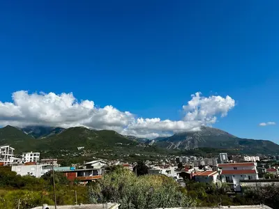 a view of a city with mountains in the background at Apartment Sunset - Private Pool & Sea View in Bar