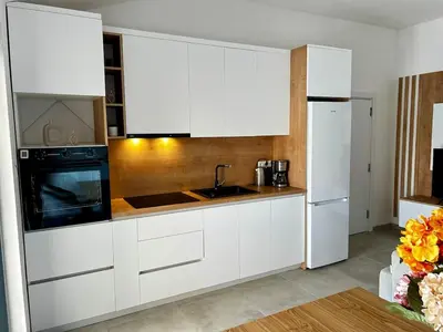 a kitchen with white cabinets and a sink and a microwave at Apartment Sunset - Private Pool & Sea View in Bar