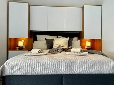 a bedroom with a large bed with towels on it at Apartment Sunset - Private Pool & Sea View in Bar