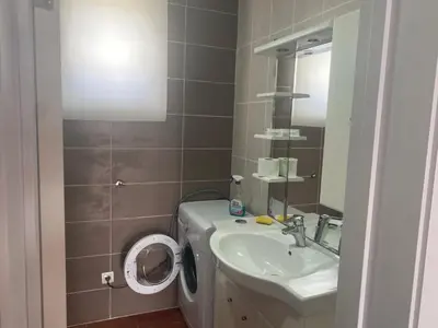 a bathroom with a sink and a toilet and a mirror at Apartment Dorada in Dobra Voda