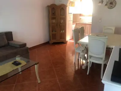 a living room with a couch and a table at Apartment Dorada in Dobra Voda
