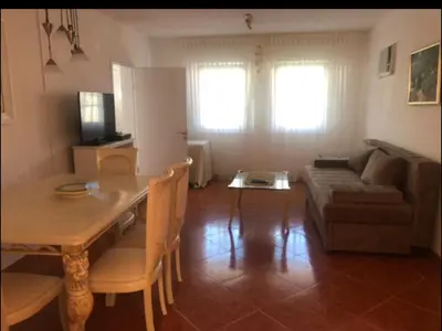 a living room with a table and a couch at Apartment Dorada in Dobra Voda