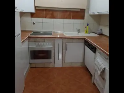 a kitchen with white appliances and a sink at Apartment Dorada in Dobra Voda