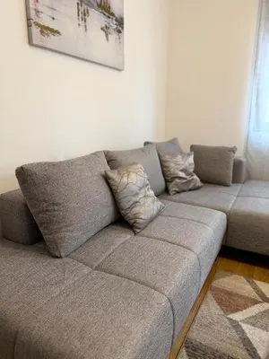 a gray couch in a living room at Montenegro Platinum Suite - New City in Podgorica