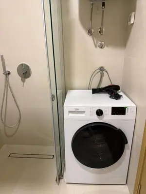 a washer and dryer in a small room at Montenegro Platinum Suite - New City in Podgorica