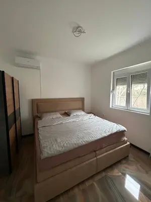 a bedroom with a bed in a room at Pause - cozy Podgorica apartment in Podgorica