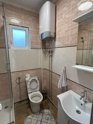 a small bathroom with a toilet and a sink at Pause - cozy Podgorica apartment in Podgorica