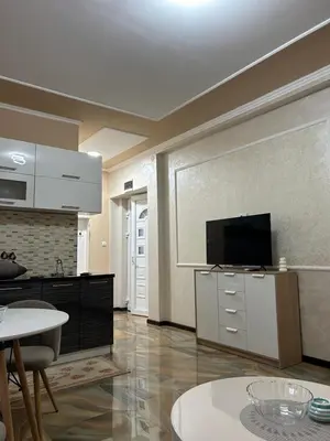 a living room with a flat screen tv on a wall at Pause - cozy Podgorica apartment in Podgorica