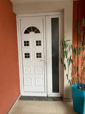 a white door in a room with a plant at Pause - cozy Podgorica apartment in Podgorica