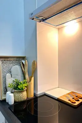 a kitchen with a counter with a stove top oven at Azure Teuta apartment with balcony in Ulcinj
