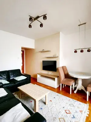 a living room with a couch and a table at MWA - City Soul Podgorica in Podgorica
