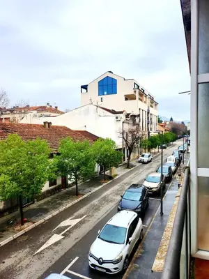 a row of cars parked on a city street at MWA - City Soul Podgorica in Podgorica