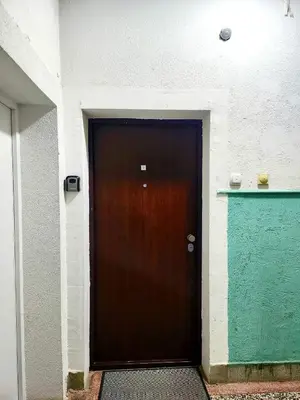 a brown door in the side of a building at MWA - City Soul Podgorica in Podgorica