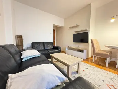 a living room with a couch and a table at MWA - City Soul Podgorica in Podgorica