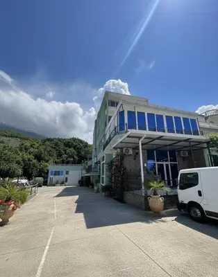 a white van parked in front of a building at Apartmani S in Dobra Voda