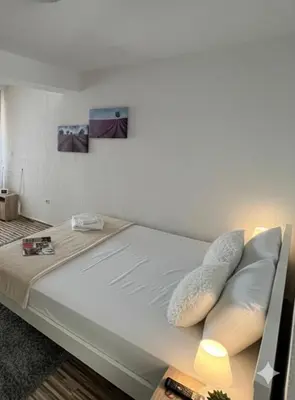 a bed with two pillows on it in a room at Apartmani S in Dobra Voda