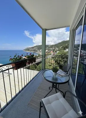 a balcony with a table and a view of the ocean at Apartmani S in Dobra Voda