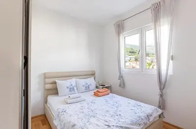 a bedroom with a bed with two towels on it at Evins Budva 1 Bedroom Apartment in Budva