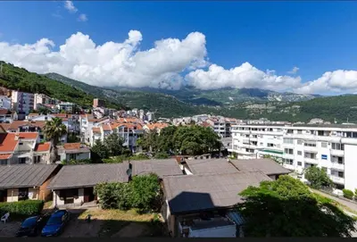 an aerial view of a city with buildings and mountains at Evins Budva 1 Bedroom Apartment in Budva