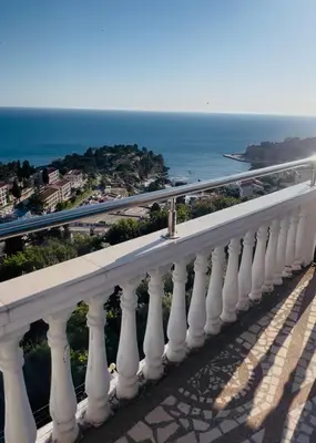 a white balcony with a view of the ocean at New ROZANA in Ulcinj