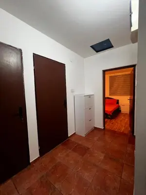 an empty room with two doors and a bedroom at Kuca in Lajkovići