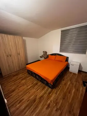 a bedroom with a bed with a teddy bear on it at Kuca in Lajkovići