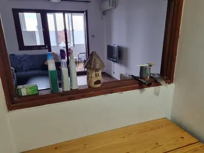 a room with a window with a shelf with bottles on it at Buddub in Budva