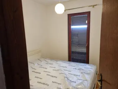 a bedroom with a bed in a room with a window at Buddub in Budva