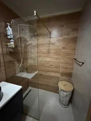a bathroom with a glass shower with a toilet at Aurora apartment in Cetinje