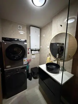 a bathroom with a sink and a washing machine at Aurora apartment in Cetinje