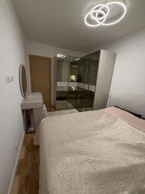 a bedroom with a bed and a sink and a mirror at Aurora apartment in Cetinje