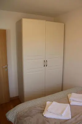 a bedroom with a bed with two white towels on it at Luxury Apartment-Aurora 33 Free Parking City Center in Podgorica