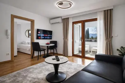 a living room with a couch and a table at Luxury Apartment-Aurora 33 Free Parking City Center in Podgorica