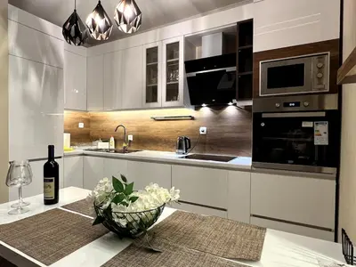 a kitchen with a table with a bottle of wine at Dobrota Luxury House with Kotor Gulf View in Dobrota