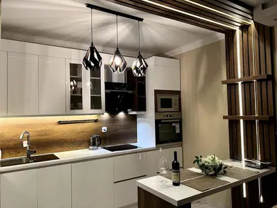 a kitchen with white cabinets and a counter top at Dobrota Luxury House with Kotor Gulf View in Dobrota