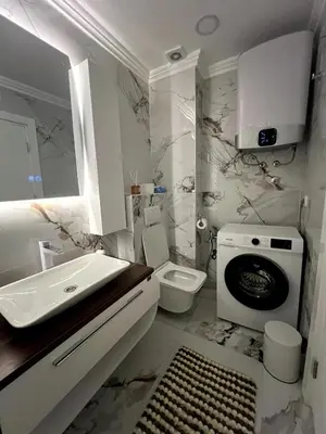 a white bathroom with a sink and a toilet at Dobrota Luxury House with Kotor Gulf View in Dobrota