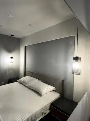 a bedroom with a bed with two lights on it at Dobrota Luxury House with Kotor Gulf View in Dobrota