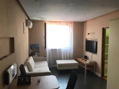 a living room with a couch and a tv at Apartment Dream in Boreti