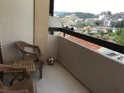 a balcony with a chair and a soccer ball at Apartment Dream in Boreti