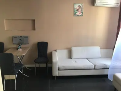 a living room with a white couch and chairs at Apartment Dream in Boreti