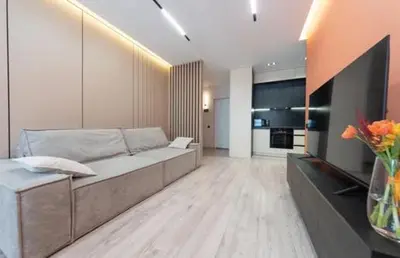 a living room with a couch and a kitchen at Apartmani Drivasko in Sveti Stefan